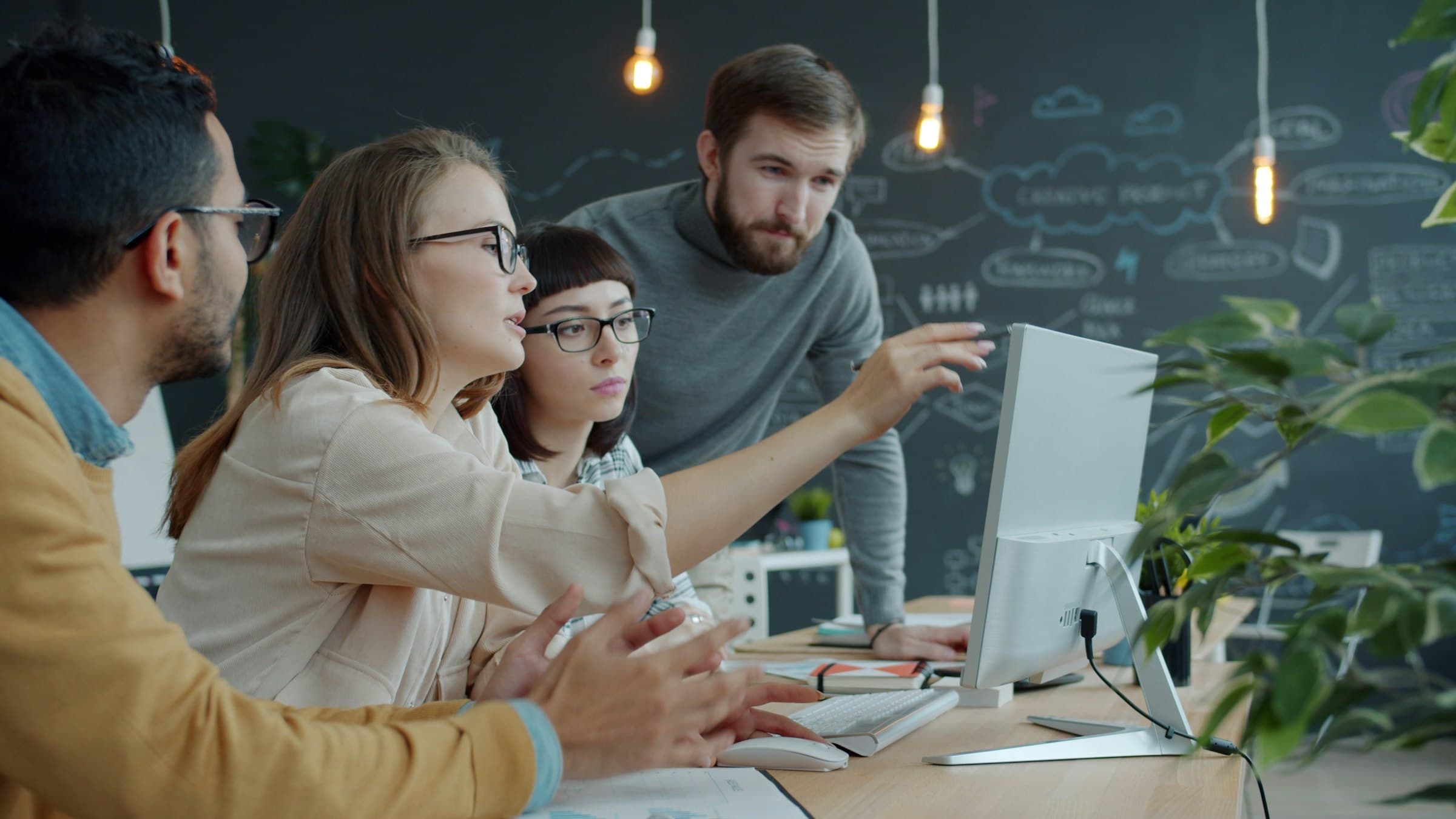 Corporate team collaborating in an office, representing Enlivo's executive search and staffing services